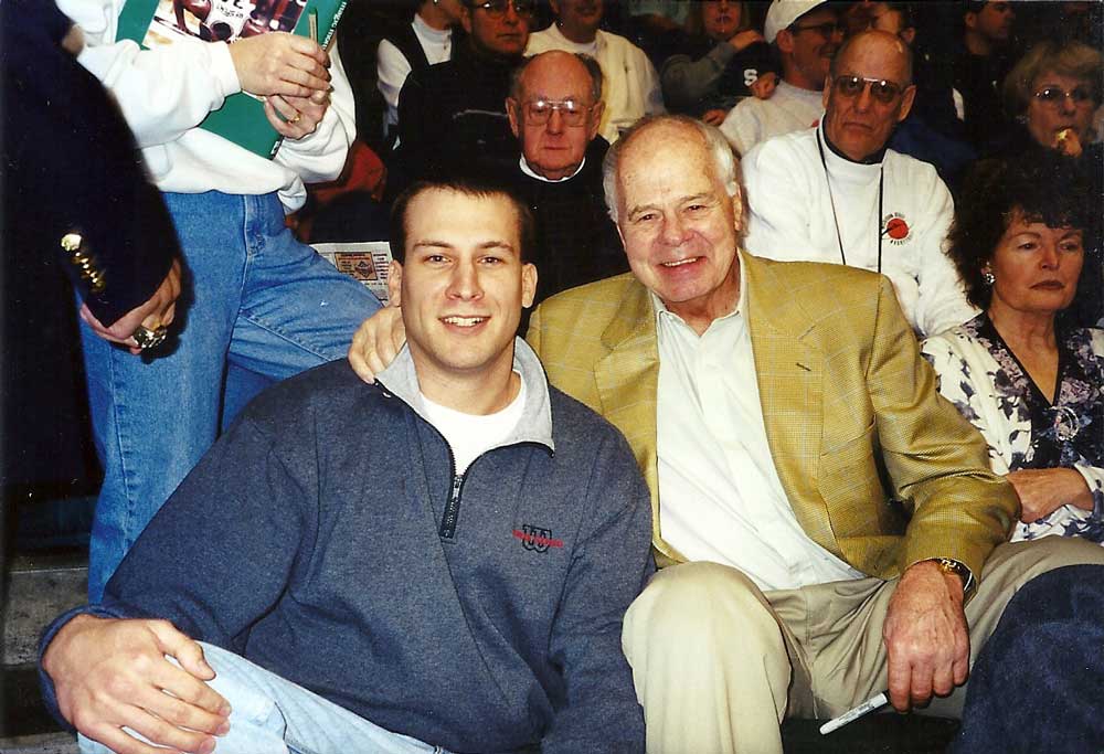 man with brown hair posing with man with white hair