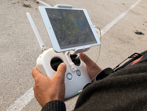 image of person holding controller for drone