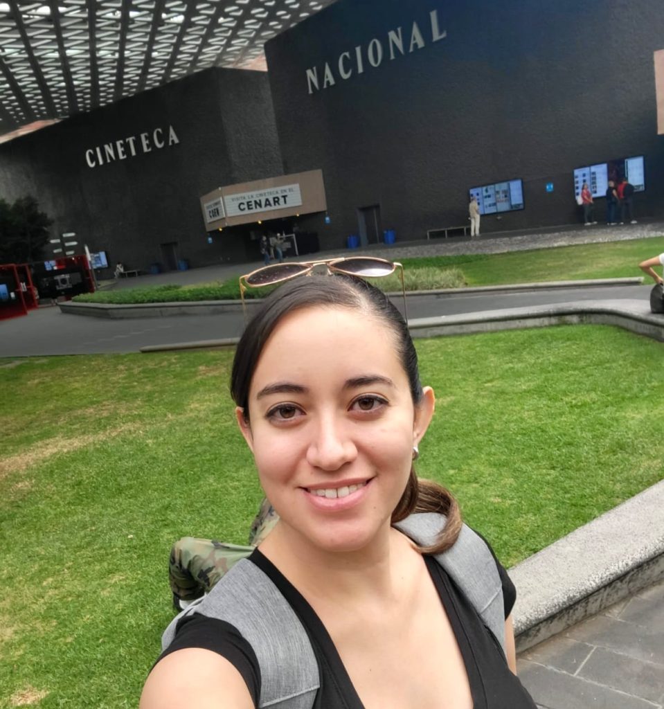 Selfie of a person outside of a black building that reads “Cineteca Nacional.”