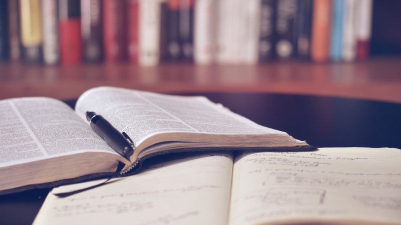 Books laying open on a desk